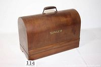 Front and side view of the curved wooden bentwood sewing machine case with handle and Singer logo