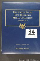 Photo of the closed blue binder titled 'The United States Vice Presidents Medal Collection Volume II of II' by PCS Stamps & Coins.