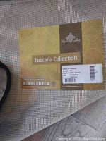 Photo of the product tag showing brand, collection, design and size details