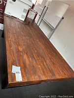 Full view of pine wood top surface showing planked construction and overall finish.