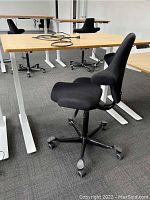 Angled view of the desk and chair showing desktop, frame, and seat profile