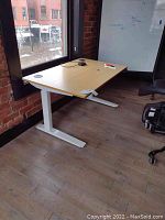 Left-front view of bamboo top desk with white adjustable legs