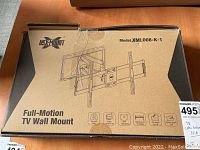 Box front showing USX Mount brand, model XML008-K-1, and illustration of TV mount.