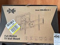 View of the box front with USX-Mount branding, model number XML008-K-1, and illustration of the full motion TV wall mount.