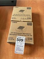 Two boxed units of Yamaha CS-700 extension microphones shown stacked with label and lot number tag visible.