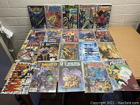 Full view of all 21 comic books laid out on table showing front covers.