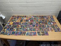Photo showing large assortment of Marvel collectible comic cards spread across a table
