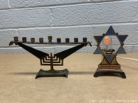 Both items shown: a Star of David lamp with "In Loving Memory" inscription and a brass menorah with nine candle holders
