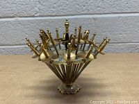 Full view of the vintage mini sword metal pick set arranged on the decorative stand showing all sword handles and detailed base.