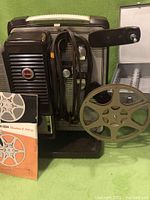 Front and side view of Cine-Kodak ShowTime 8mm film projector with manual and attached power cord