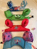 Top view of all four Puddle Jumpers arranged vertically on a flat surface showing different colors and designs.