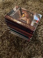 Stack of 12 Guardians of Ga'Hoole books from the series, books 1-12, on carpeted floor.
