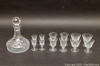 Photo showing Stuart's cut crystal decanter and three sets of four stemware glasses each, arranged in escalating height