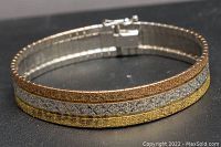 Front view showing the tri-gold tone bracelet with three distinct textured bands in yellow gold, rose gold, and white silver tones.