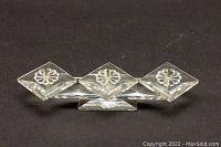 Clear Swarovski crystal tri-tapered candleholder shown against black background from front angle.