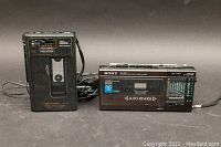 Realistic VSC-2001 cassette recorder vertical unit with cassette inserted and connected power charger cable