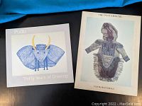 Two Inuit art books with covers visible: Pudlo Thirty Years of Drawing and The Inuit Amautik Book