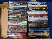 Photo showing stacks of 42 DVDs including Schmidt & Recount, Layer Cake, and various movie titles.