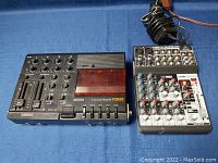 Fostex X-15 multitracker and Behringer Xenyx QX1002USB mixer placed on blue cloth background. Multitracker shows multiple knobs and cassette slot. Mixer shows input ports, buttons and knobs.