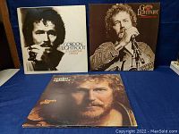 Front view of three Gordon Lightfoot vinyl albums with cover art visible showing artist portraits.