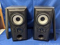 Pair of Mission 701 speakers without grille covers showing driver and tweeter arrangement.