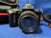 Front view of the Nikon F-401 camera with attached AF Nikkor 35-70mm lens showing lens branding and front glass