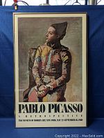 Framed poster full front view against blue backdrop