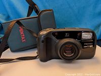 Camera, case, and remote shown with camera facing forward