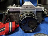 Front view of Pentax K1000 SLR with attached Pentax-A 50mm f/2 lens