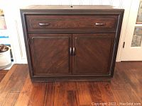 Front view of closed cabinet showing single drawer and double-door lower storage.