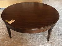 Top view of round dark wooden coffee table showing smooth surface with minor wear.