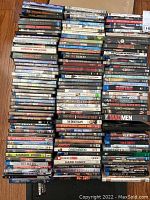 Photo showing a large collection of DVDs stacked upright and horizontally, visible titles include Quentin Tarantino and The Exorcist.