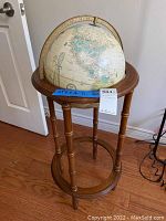 Full view of the globe mounted on the wooden stand showing its size and structure