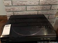 Turntable with closed dust cover showing the top and front view with Sony branding.