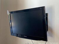 Front view of Panasonic 37 inch TV mounted on wall with wall mount visible.