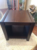 Front view of heavy cube end table showing wood grain top and open shelf below