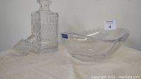 Photo of the clear crystal decanter with stopper next to Villeroy & Boch crystal bowl with a label.