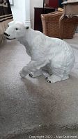 Side view of white porcelain bear figurine showing shape, size and detailed textured fur.