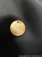 Obverse view showing calligraphic tughra and milled edge against dark background