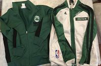 Front side of two boys' Boston Celtics tops: green zip-up top and white/green Adidas jacket