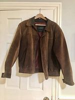 Front view of a men's brown leather jacket with classic collar and elastic sides at hem