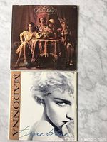 Front view of The Pointer Sisters album cover showing four women seated around a table with flowers.