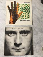 Front covers of Genesis Invisible Touch and Phil Collins Face Value LP records.