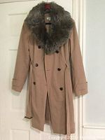 Front view of beige Calvin Klein rain coat with large detachable faux fur collar.