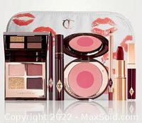 All 7 makeup items arranged with the makeup bag, showing the palette, mascara, blusher, lipstick, lip liner, and lip gloss with packaging details.