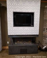 Front view of display stand with TV and fireplace