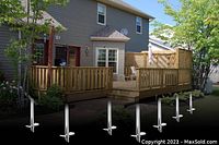 Deck supported on galvanized screw piles installed under framing