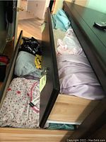 Two open dresser drawers filled with assorted women's pajamas, nightgowns, and leisure wear, showing variety of colors and patterns.