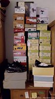 Stack of assorted shoe boxes on dresser, showing over 30 original boxes