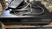 Top view of RCA VCR player with remote and cables on top showing model details and physical condition.
